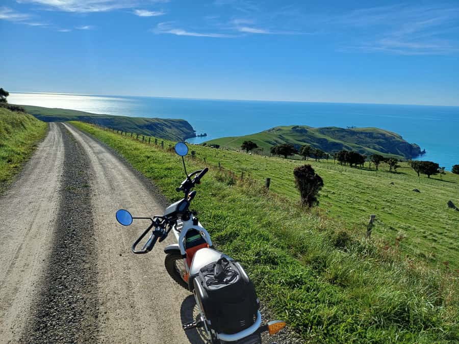 Akaroa: Lonely Beach Trail by E-Scooter. selfguided day out - Lonely roads to three beaches: where you actually swim